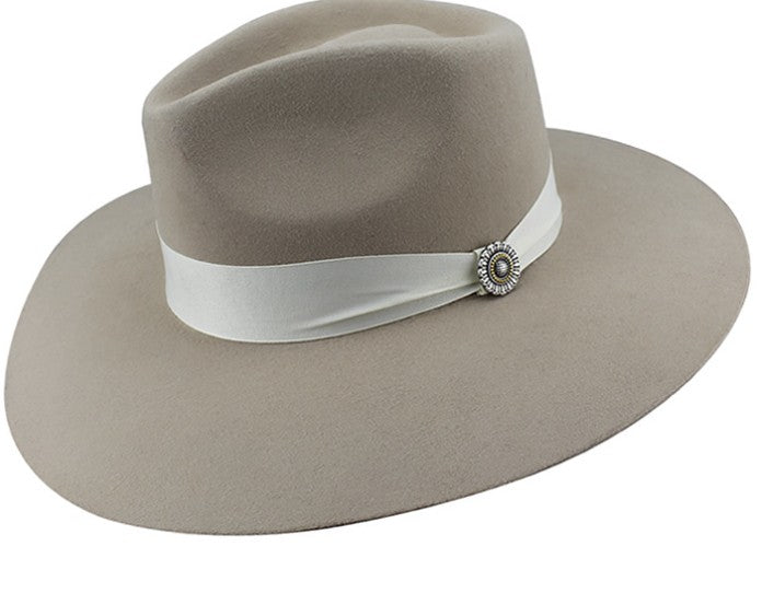 Spirit Warrior Provisions Sofia beige felt hat with a pinch front, white ribbon band, and sunflower concho detail.