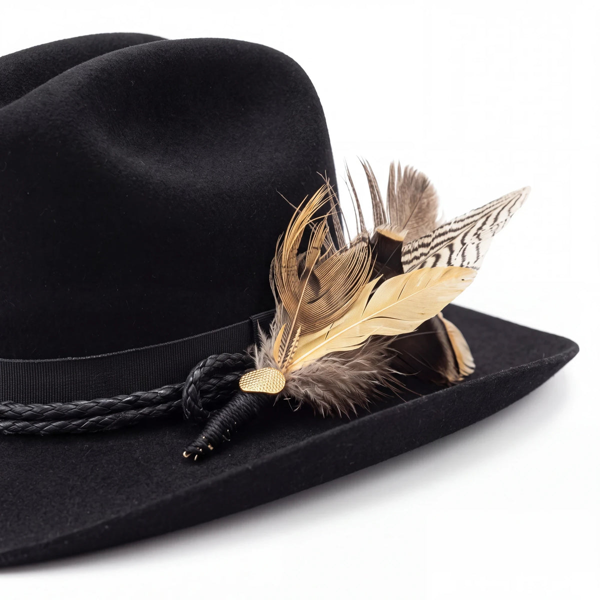 Spirit Warrior Provisions black felt cattleman hat featuring a braided leather hatband and decorative feather accents.