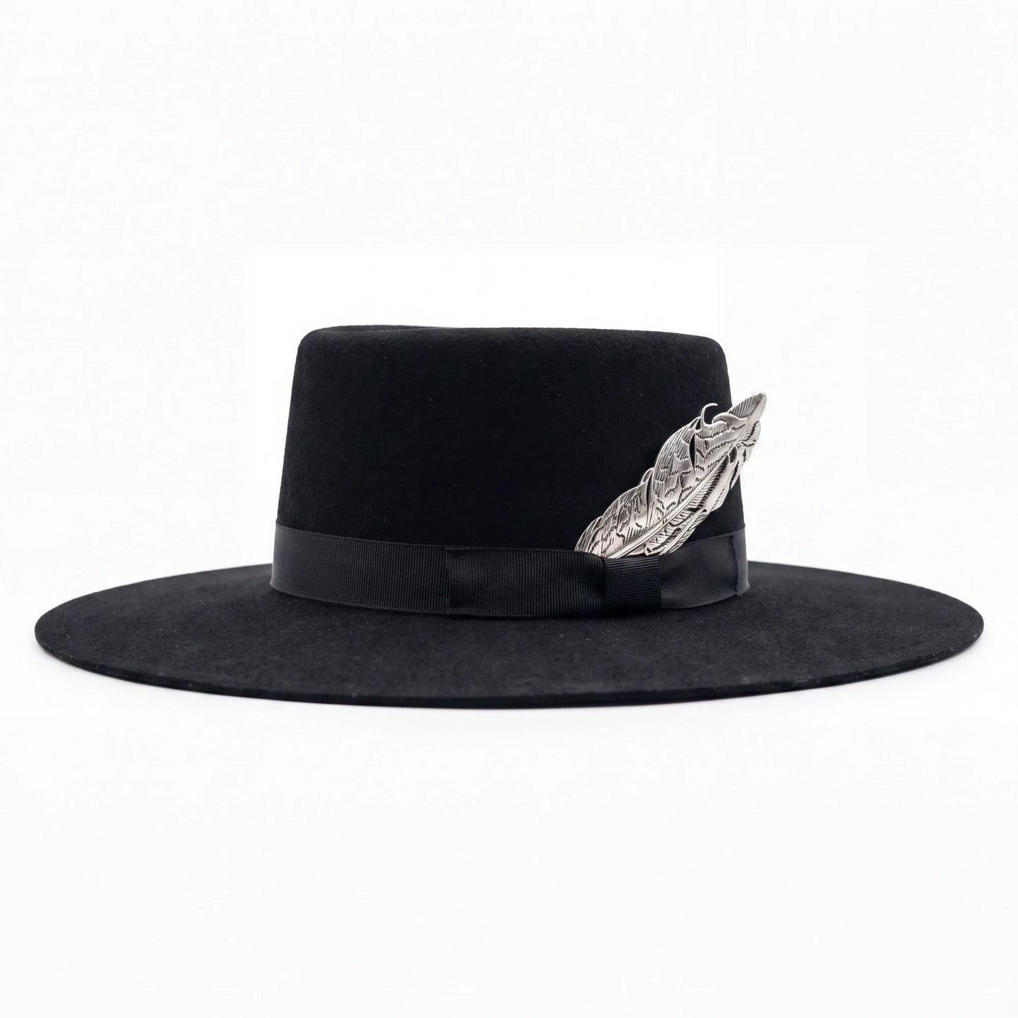 Spirit Warrior Provisions black felt gambler hat with a 4-inch flat brim, grosgrain ribbon, and silver pheasant tail.