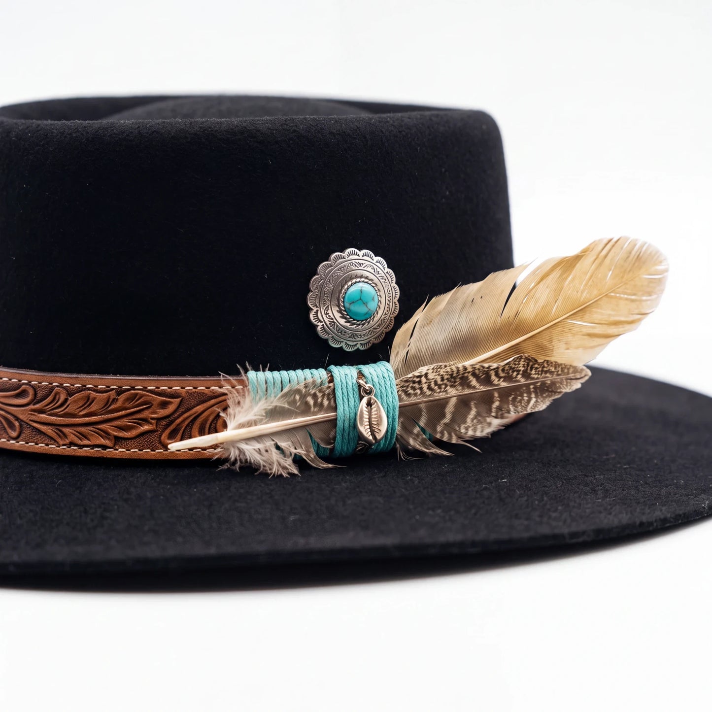 Spirit Warrior Provisions black gambler felt hat with a tooled leather band, turquoise concho, and decorative feathers.