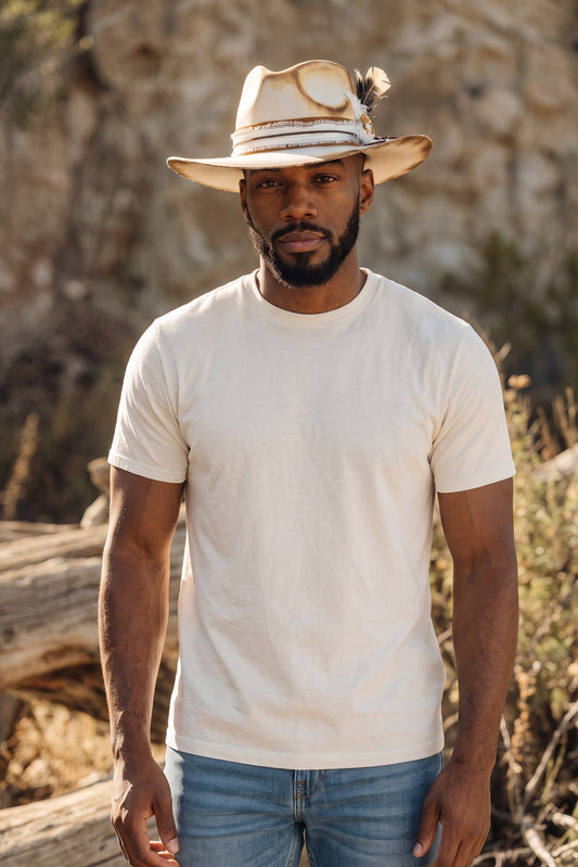 Spirit Warrior Provisions Camino sand felt hat with camel leather band and concho worn by a man in a desert setting