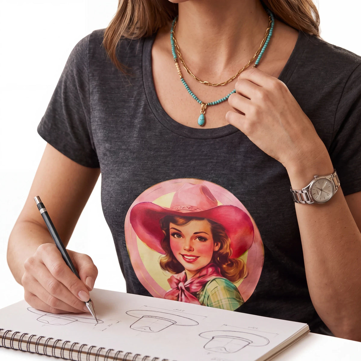 Spirit Warrior Provisions charcoal grey cotton graphic tee featuring a retro cowgirl illustration on a woman sketching