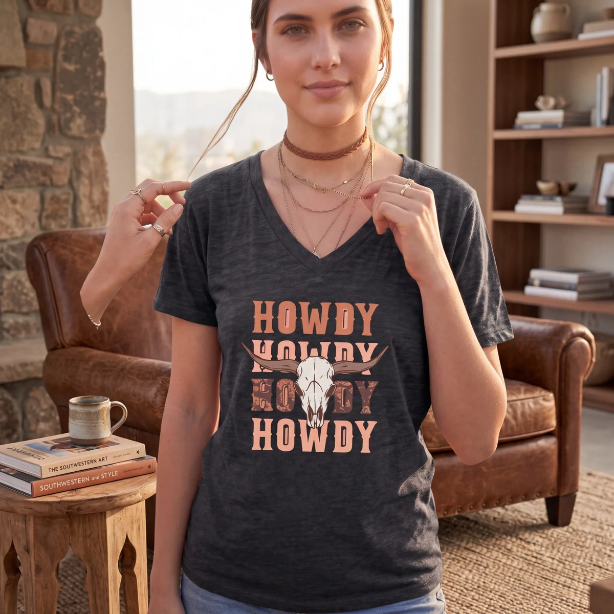 Spirit Warrior Provisions charcoal grey V-neck cotton T-shirt with a rustic Western cow skull Howdy graphic print.