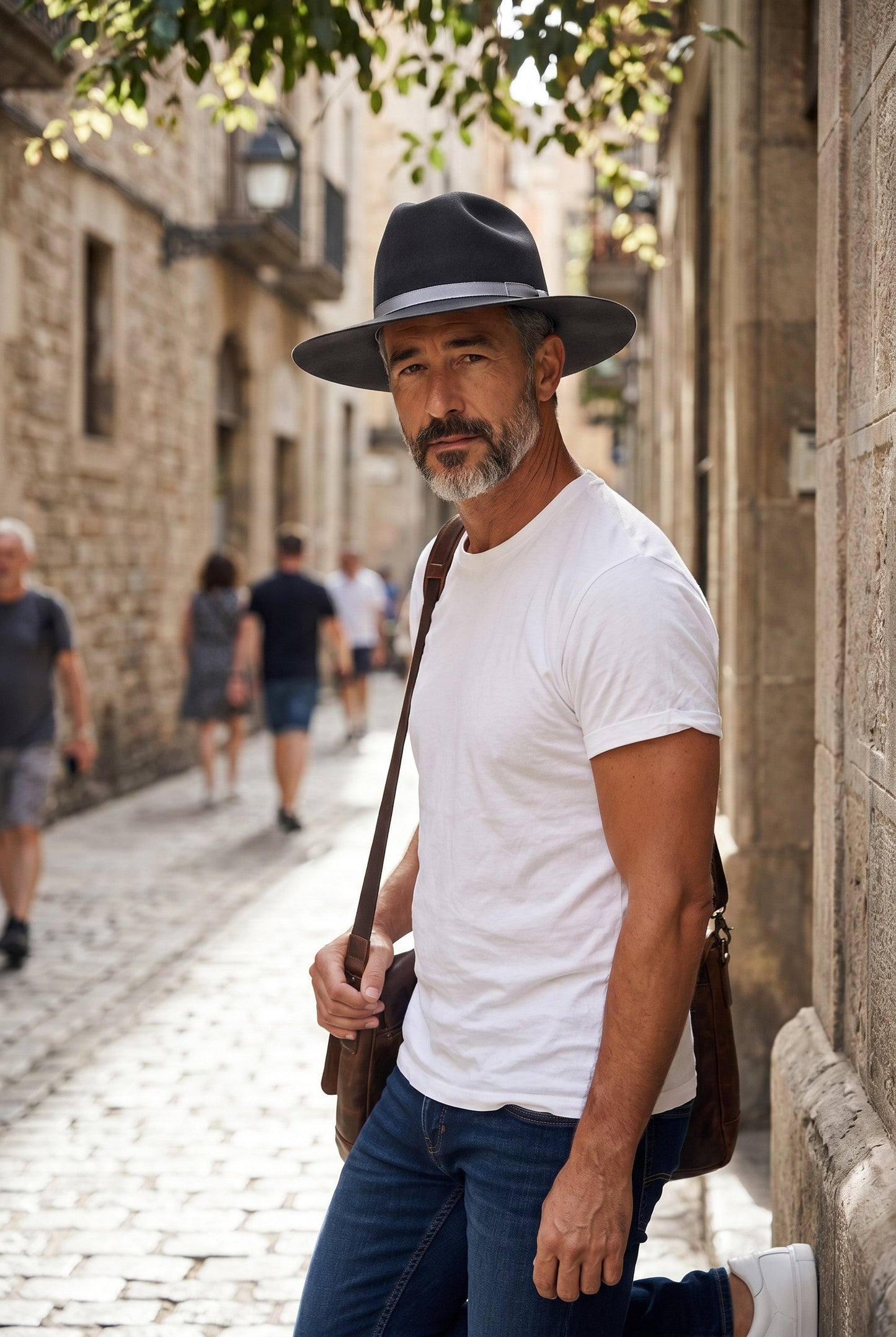 Spirit Warrior Provisions charcoal fine felt cattleman cowboy hat with gray ribbon band worn by a man in a city alley