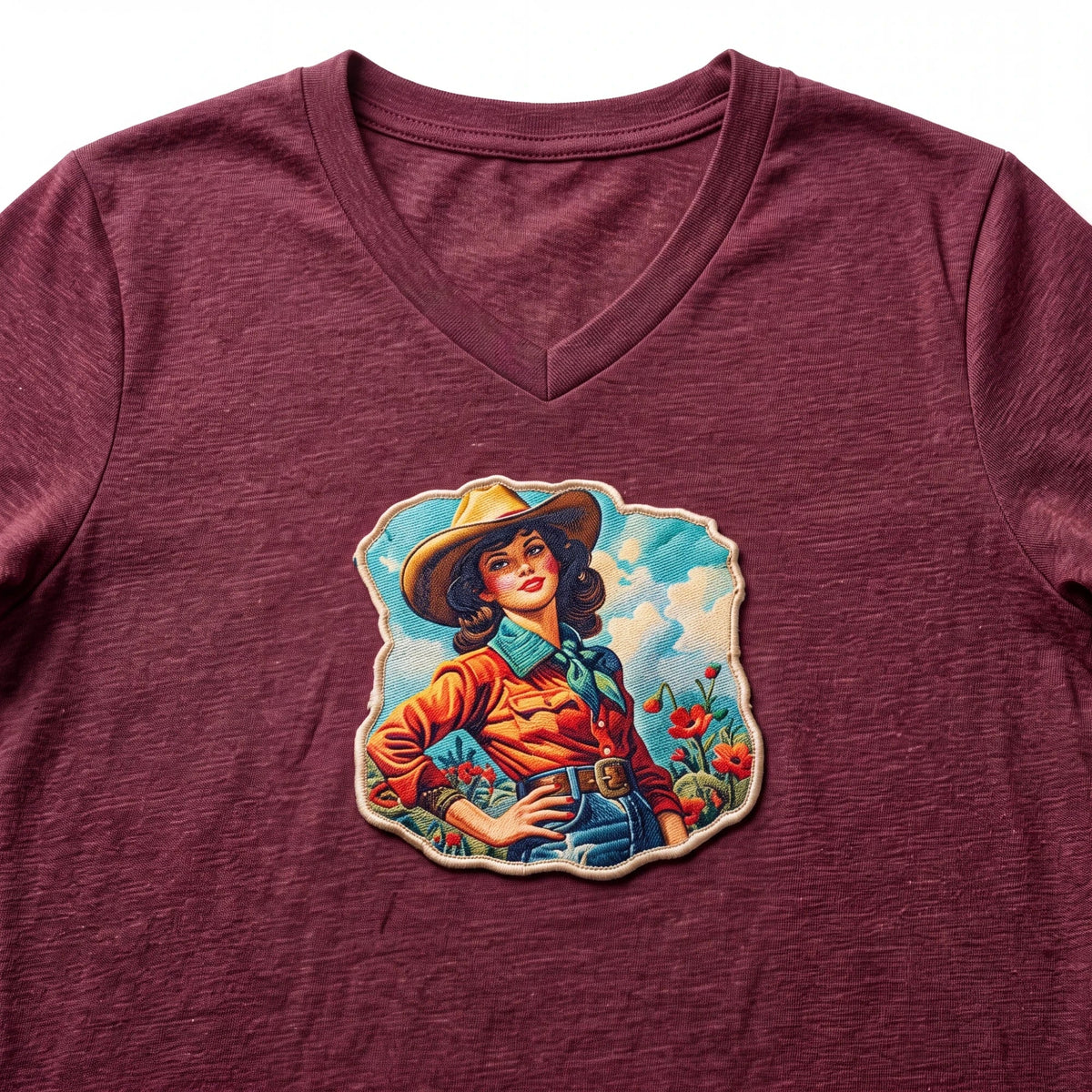 Spirit Warrior Provisions maroon v-neck t-shirt featuring a vintage cowgirl graphic with a western desert scene.