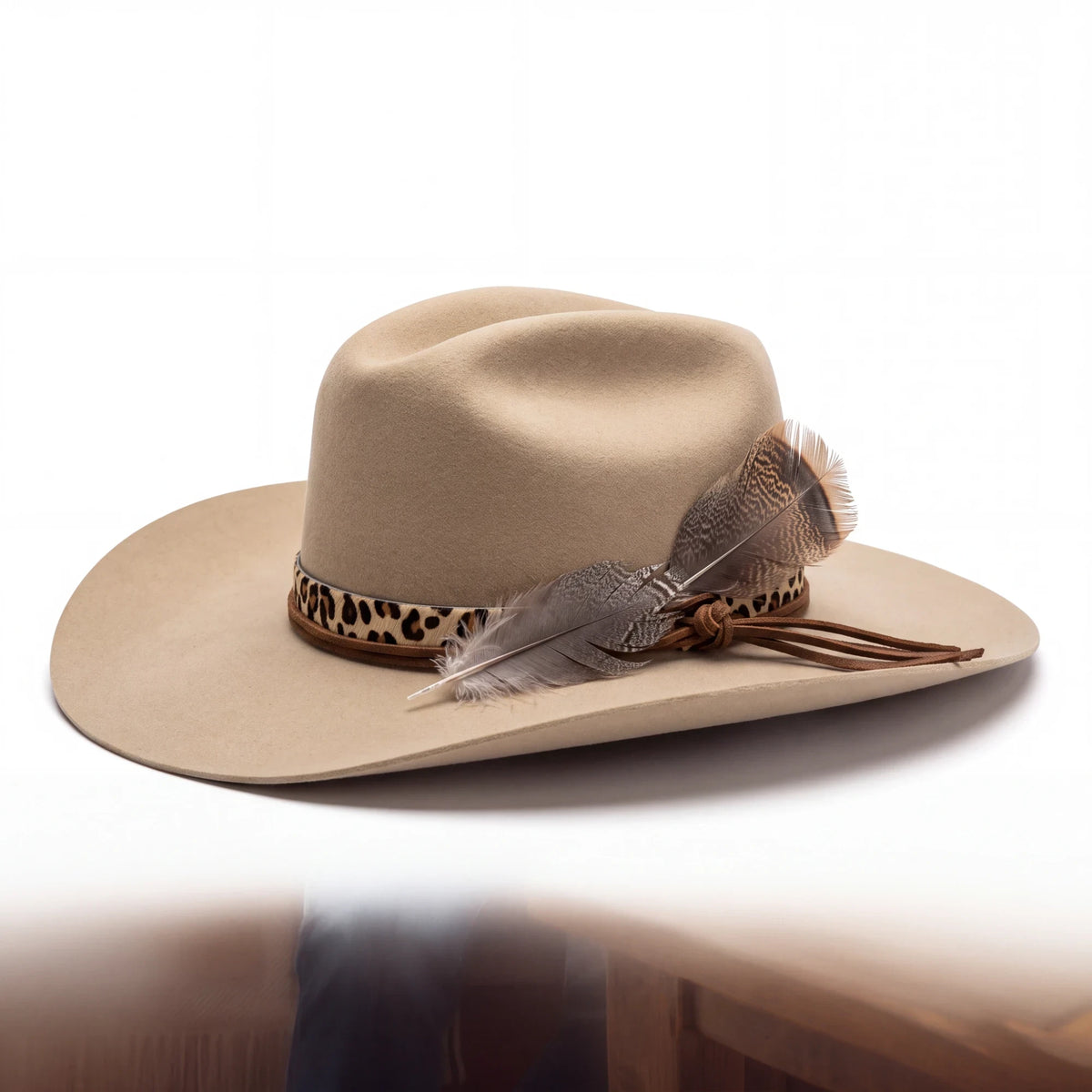 Spirit Warrior Provisions Ocelote sand 6X felt cattleman hat with cheetah print leather band and feather detail.