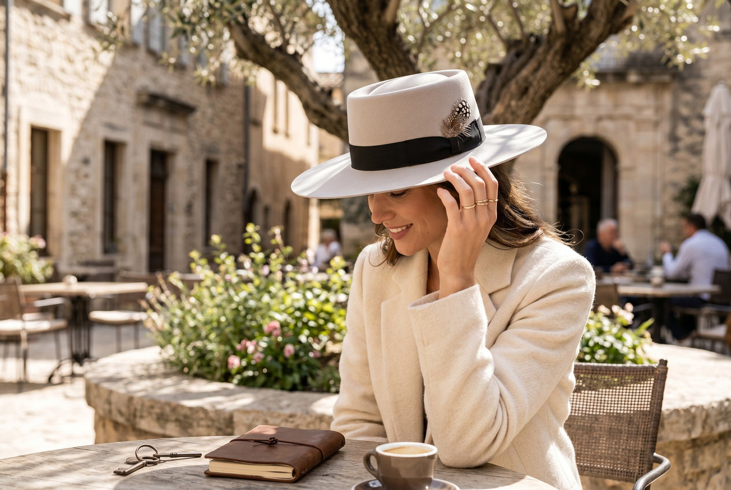 Spirit Warrior Provisions sand gambler hat with flat brim and rose gold paint splatter, worn by a woman at a cafe.