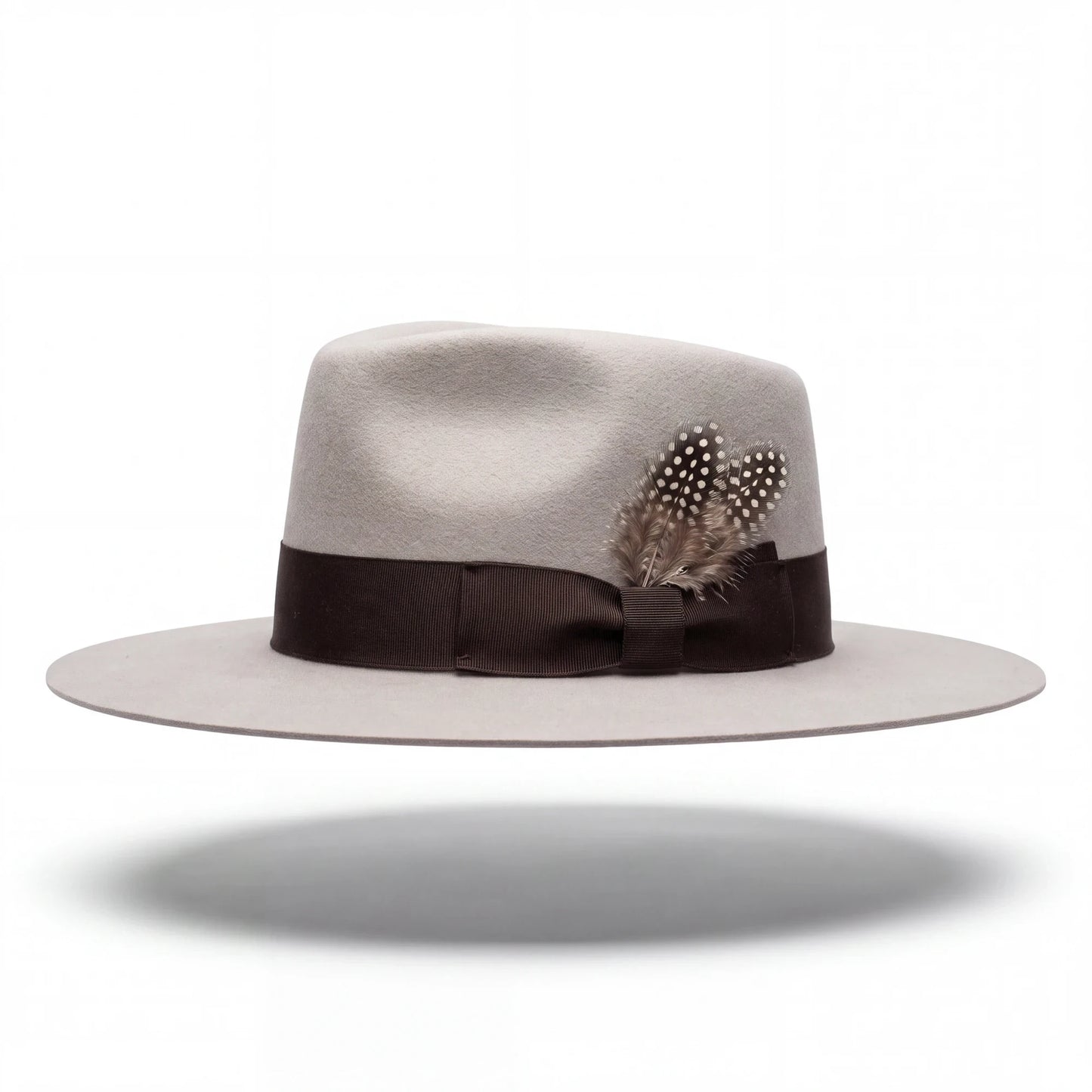 Spirit Warrior Provisions sand gambler hat with a flat brim, brown grosgrain ribbon, and decorative spotted feathers reshaped version by hatter