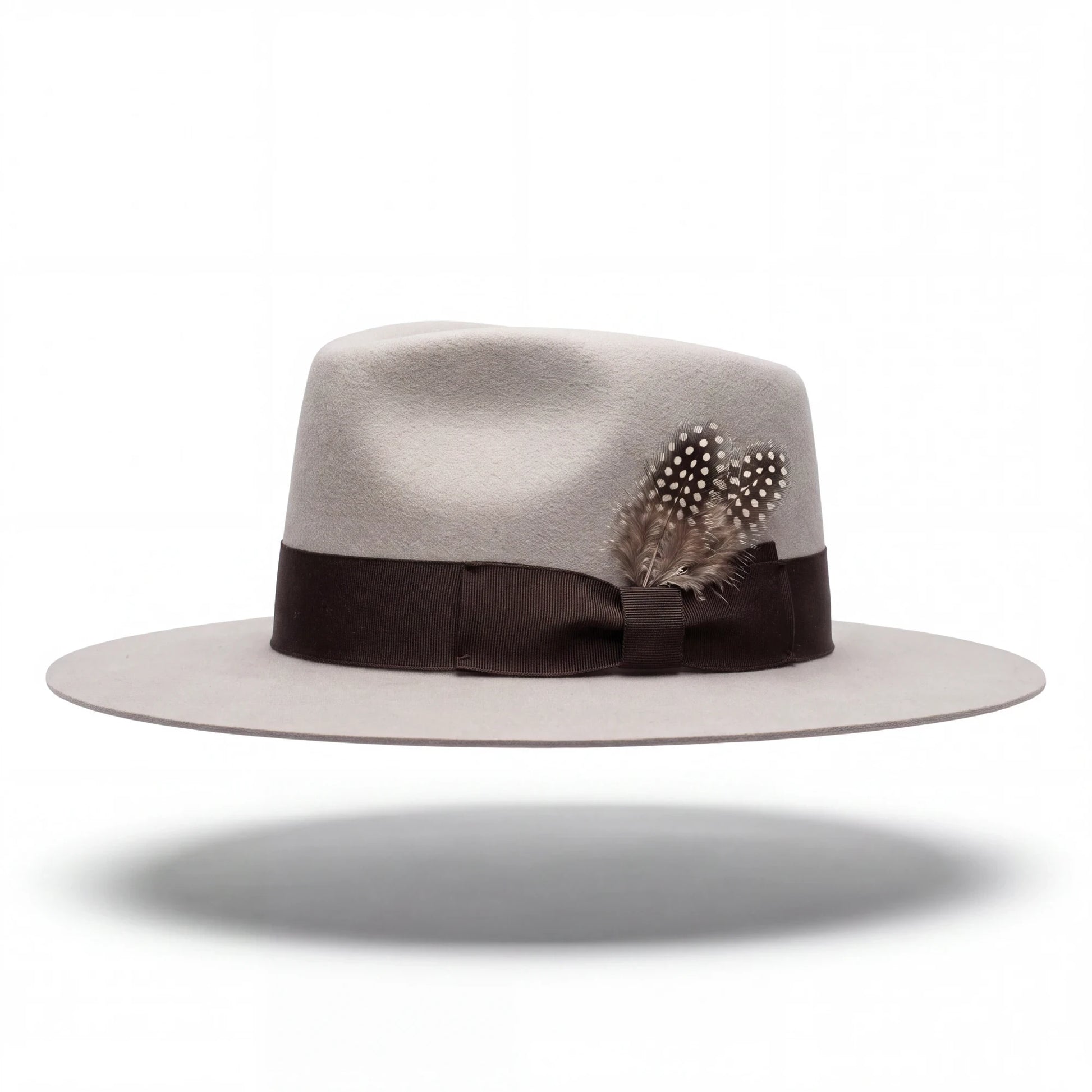 Spirit Warrior Provisions sand gambler hat with a flat brim, brown grosgrain ribbon, and decorative spotted feathers reshaped version by hatter