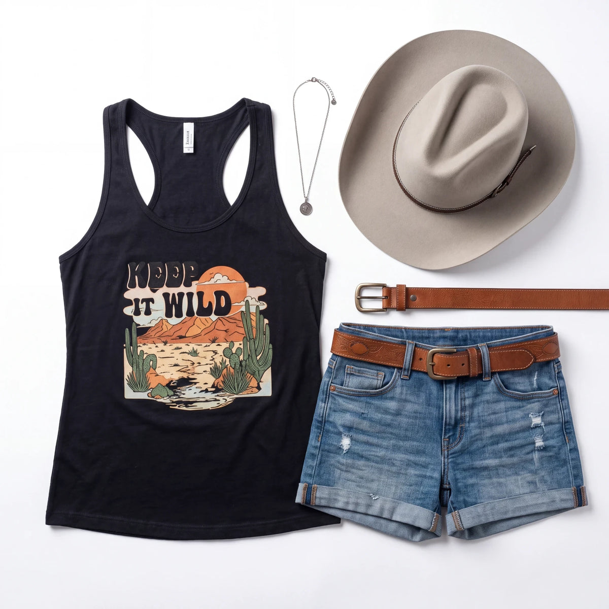 Spirit Warrior Provisions sand Western hat with tooled leather band, black graphic tank top, denim shorts, and belt.